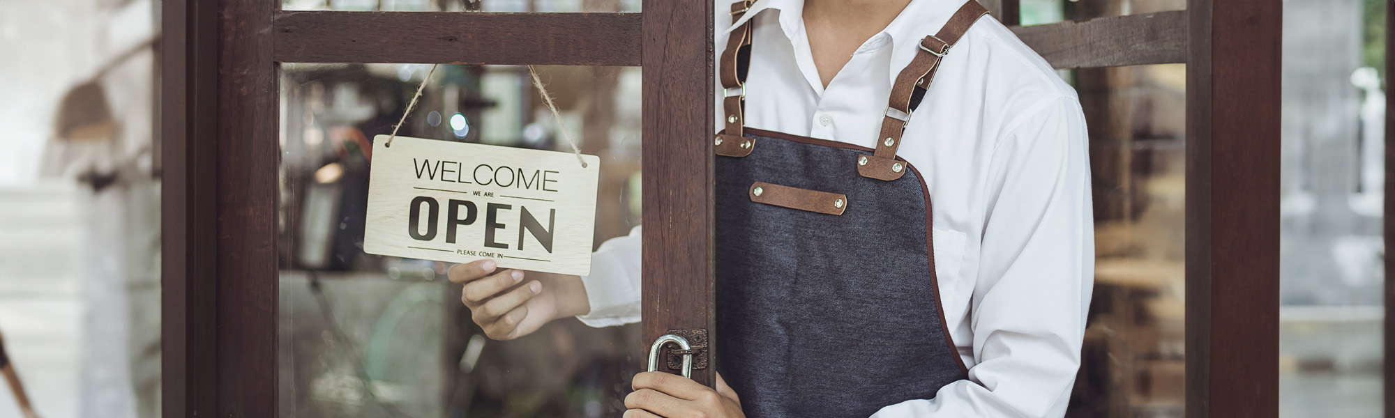 store owner turning open sign